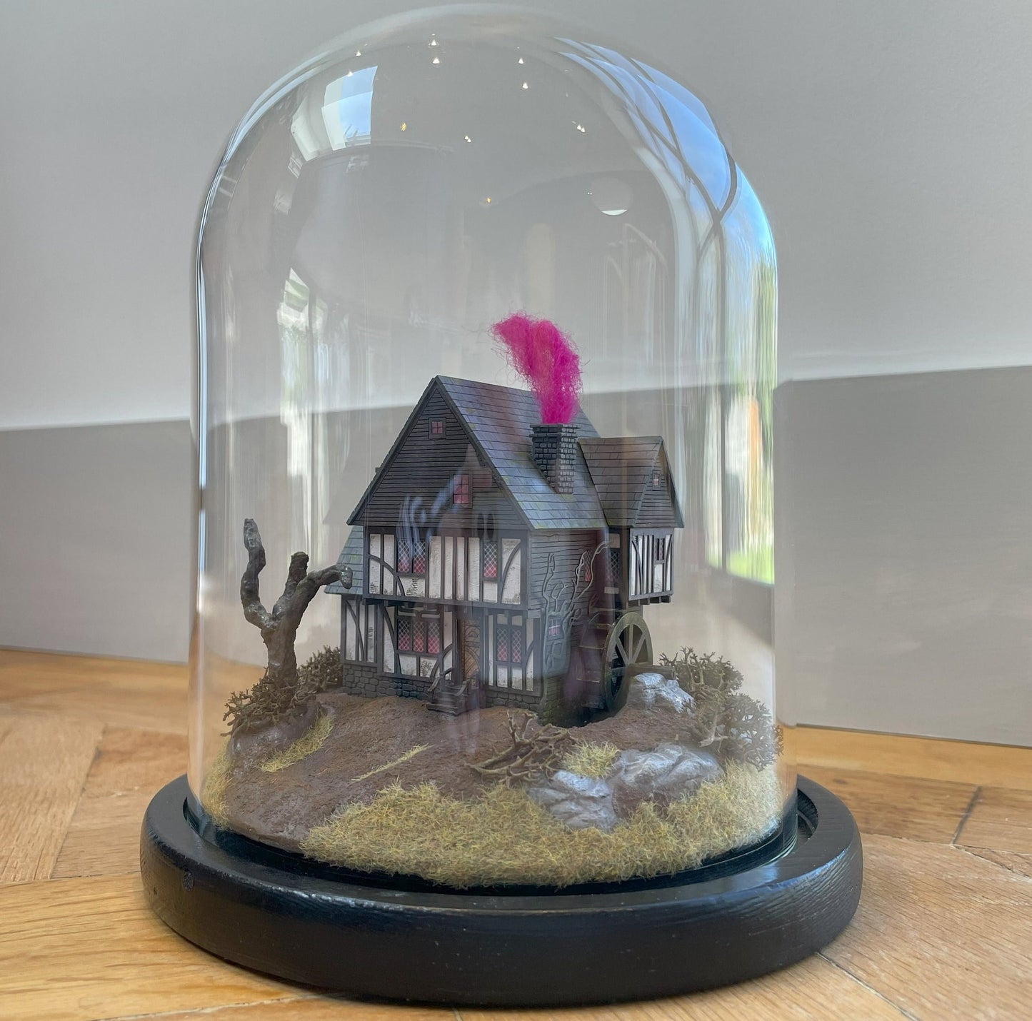 Model of Hocus Pocus cottage movie house in glass dome. Sanderson Sisters Cottage