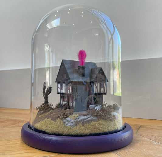 Model of Hocus Pocus cottage movie house in glass dome. Sanderson Sisters Cottage