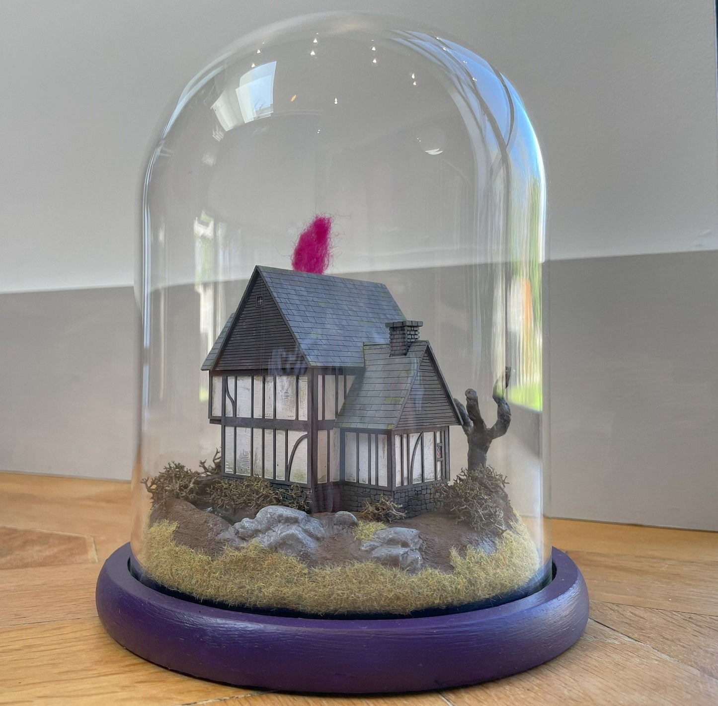 Model of Hocus Pocus cottage movie house in glass dome. Sanderson Sisters Cottage