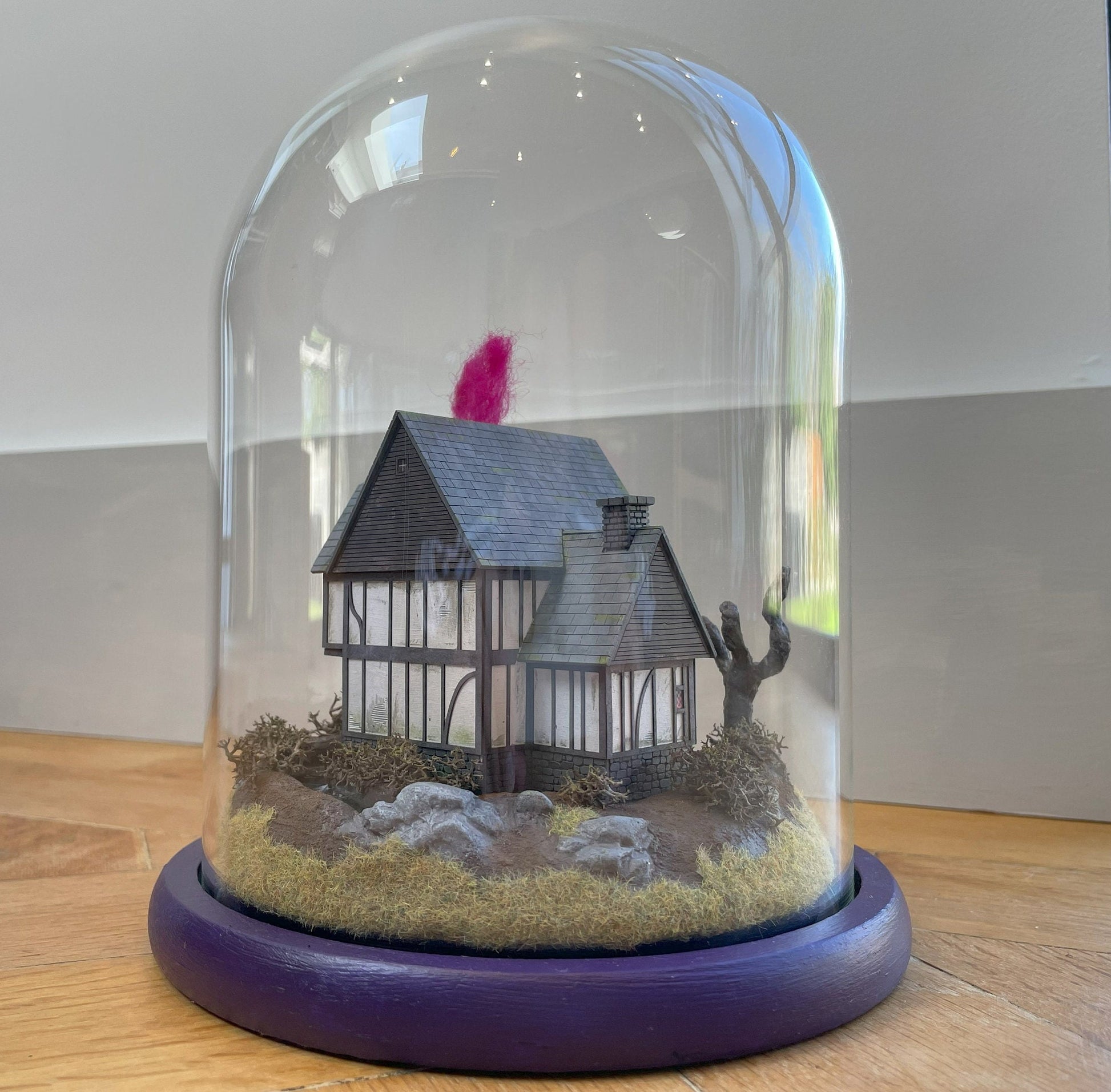 Model of Hocus Pocus cottage movie house in glass dome. Sanderson Sisters Cottage