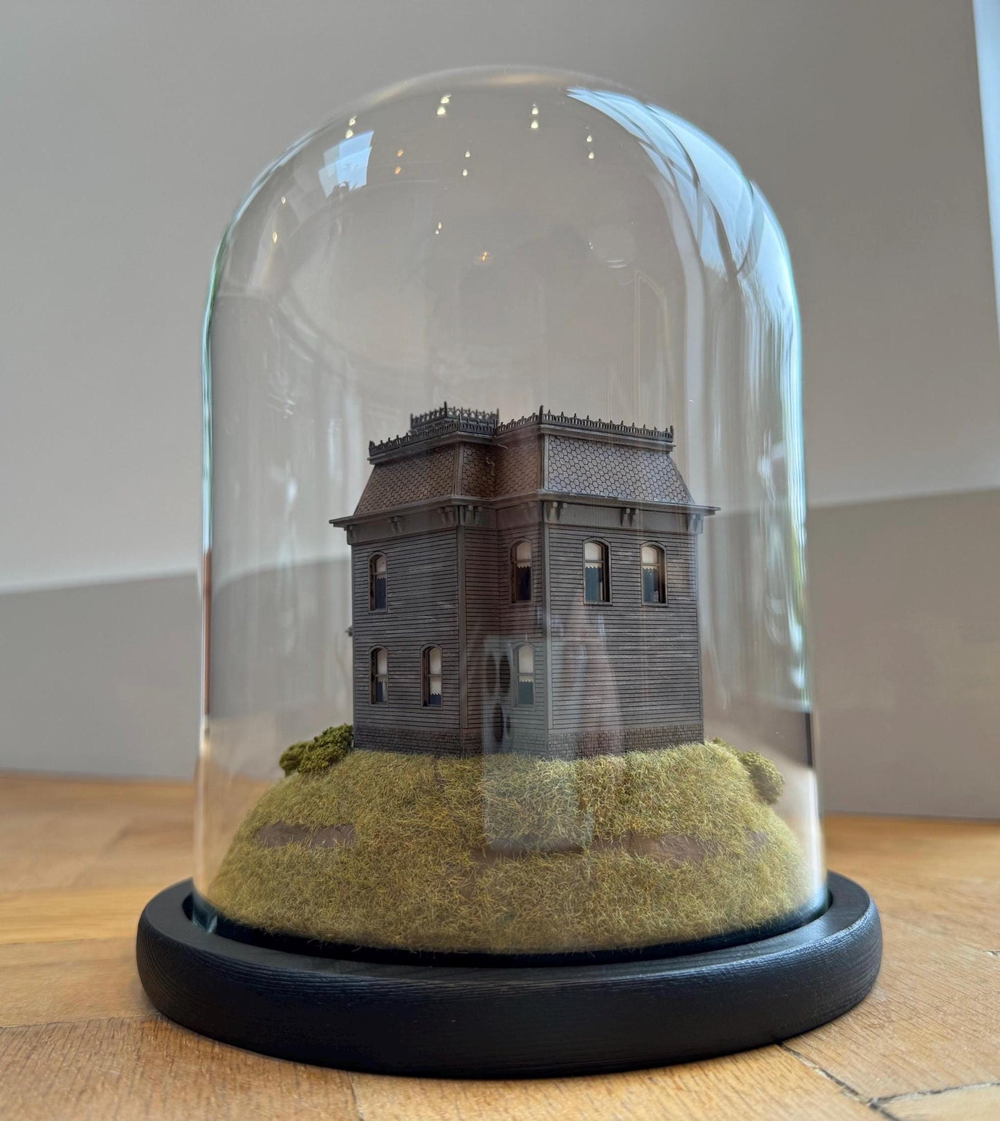 Model of Psycho movie house in glass dome. Bates Motel. Hitchcock