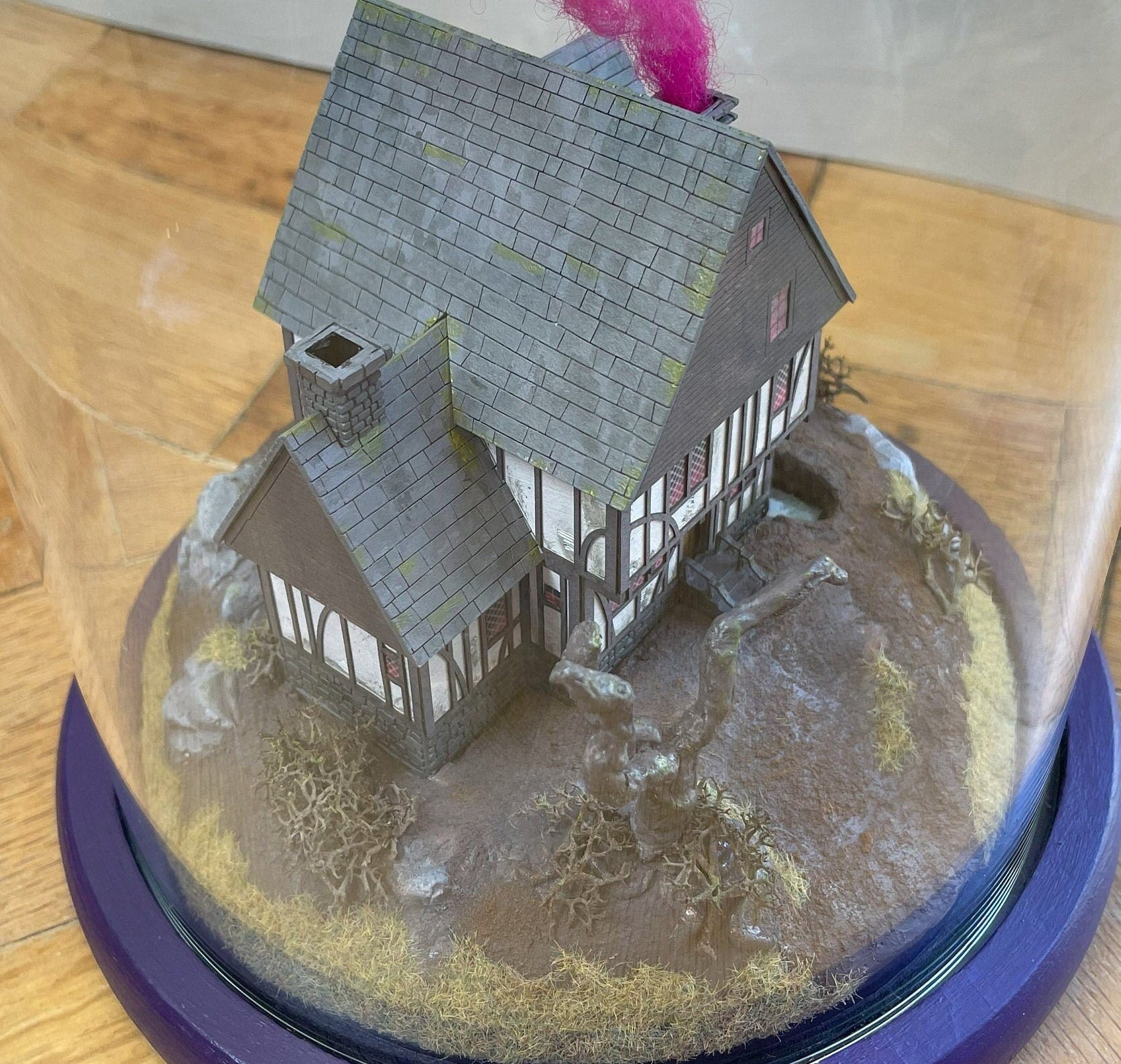 Model of Hocus Pocus cottage movie house in glass dome. Sanderson Sisters Cottage