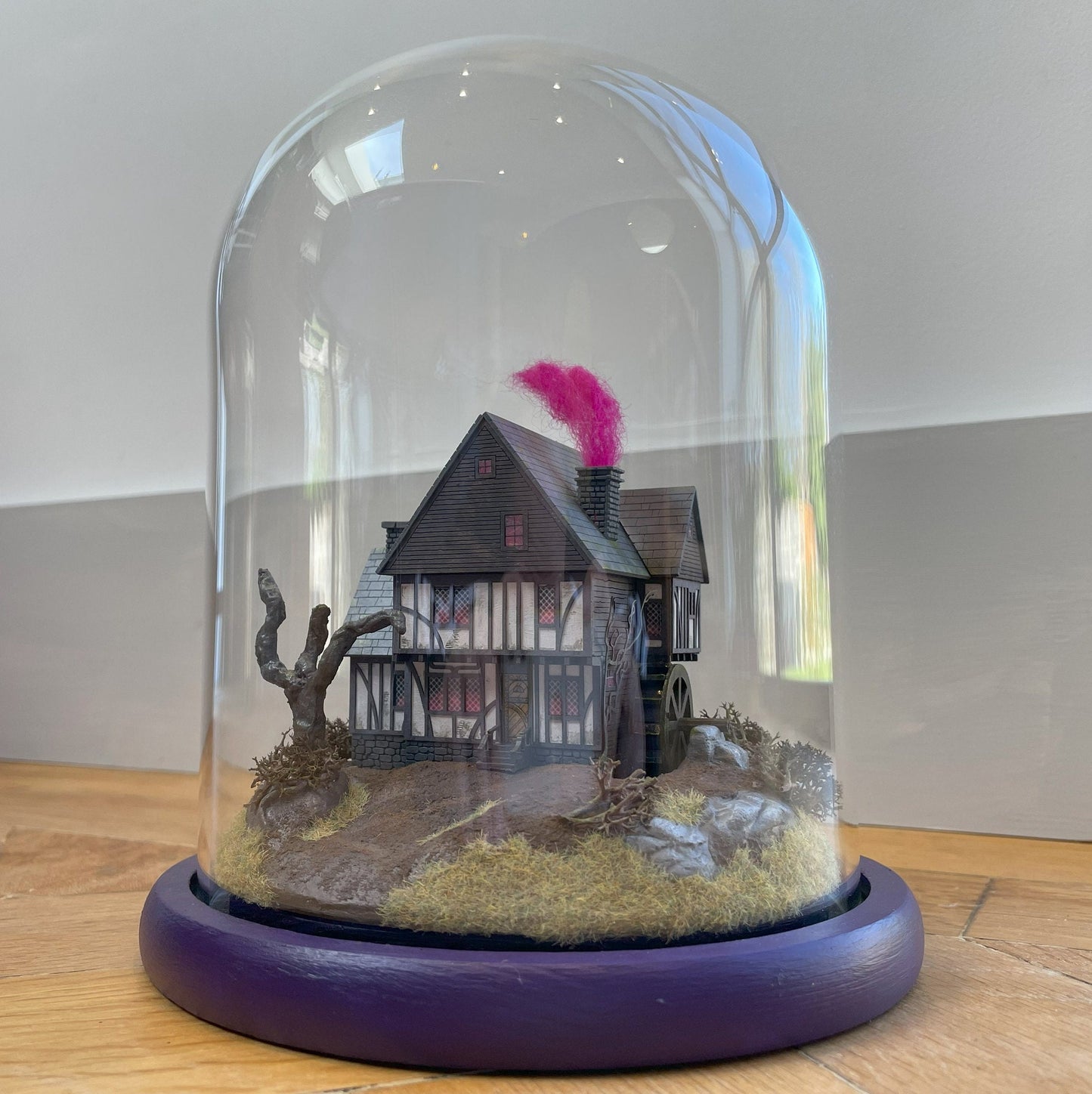 Model of Hocus Pocus cottage movie house in glass dome. Sanderson Sisters Cottage