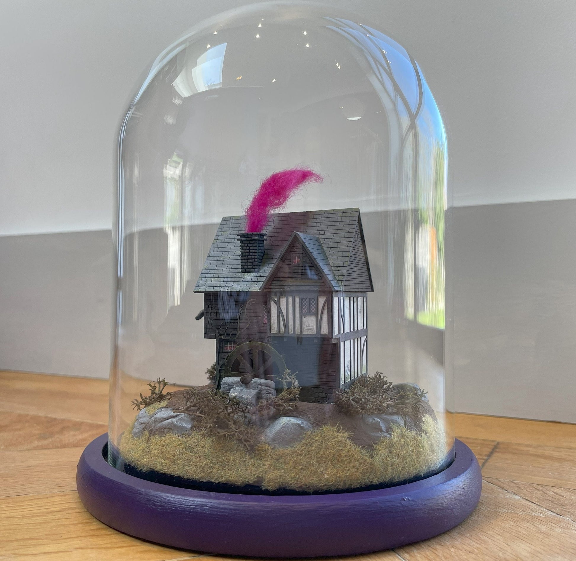 Model of Hocus Pocus cottage movie house in glass dome. Sanderson Sisters Cottage