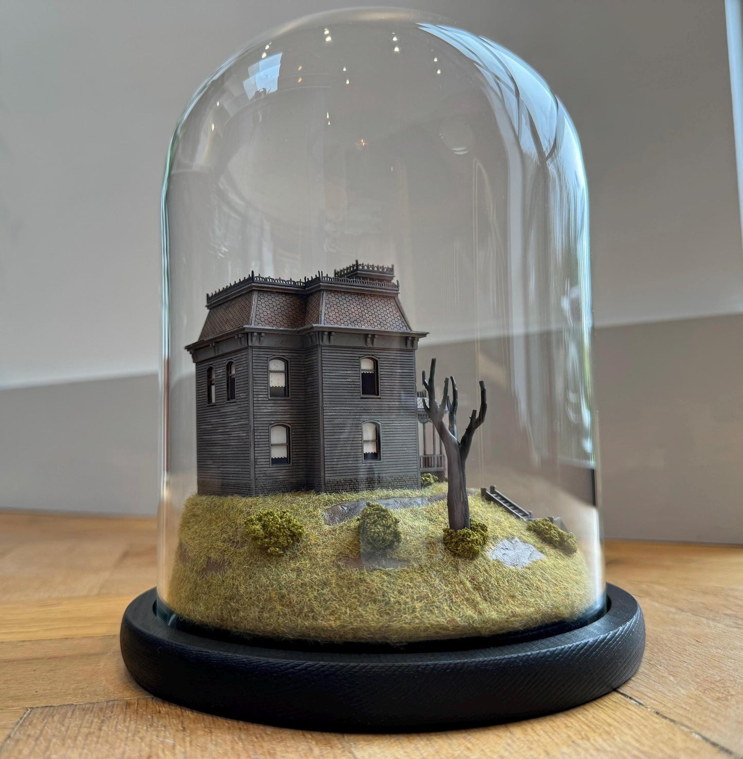 Model of Psycho movie house in glass dome. Bates Motel. Hitchcock